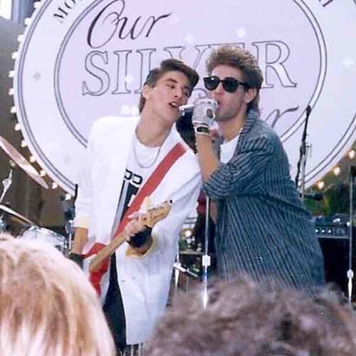 Bobby and Jason performing on stage in the 80s, Jason on guitar, Bobby on the mic