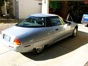 Silver General Motors EV1 parked in an Arizona driveway